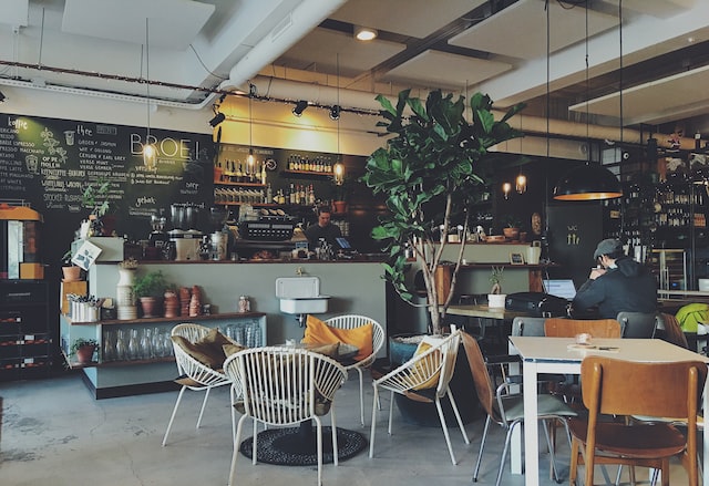 image of a café with a variety of chairs and a bardesk